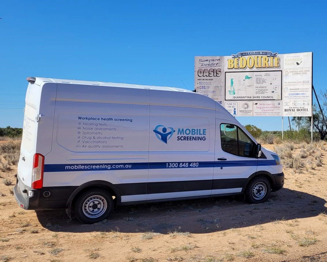 Mobile Screening Australia van parked near the Bedourie town sign in remote western Queensland, demonstrating the company’s ability to deliver onsite workplace health services - including hearing tests, skin checks, health checks, drug and alcohol testing, spirometry, noise assessments and air quality monitoring - to regional and remote worksites across Australia.