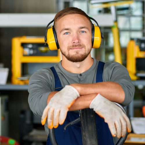 Mobile health professional conducting workplace hearing test for employee wearing headphones